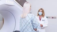 The Department of Radiation Oncology chair speaking with a patient before getting ethos radiation therapy.